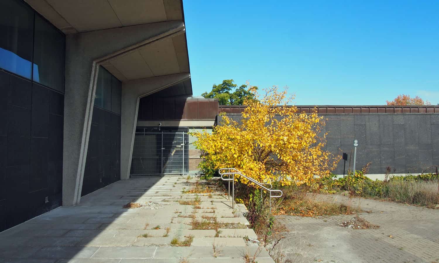 Looking towards the entry that is currently covered with plywood and construction hoarding