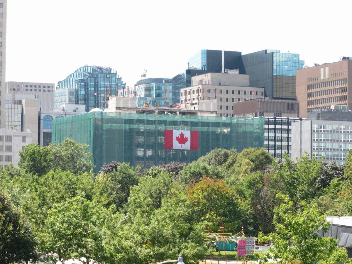 Lorne Building demolition visible above the trees in Confederation Park