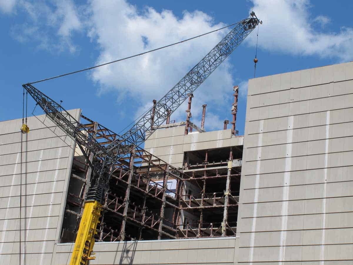 West end of building with crane in foreground