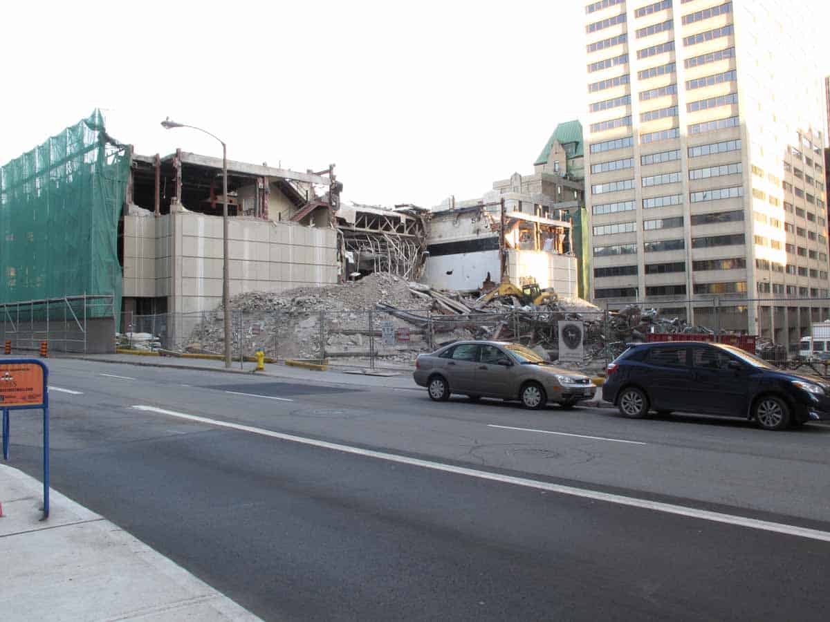 Detail of west (rear) elevation opened up with debris pile in foreground sorted into different materials