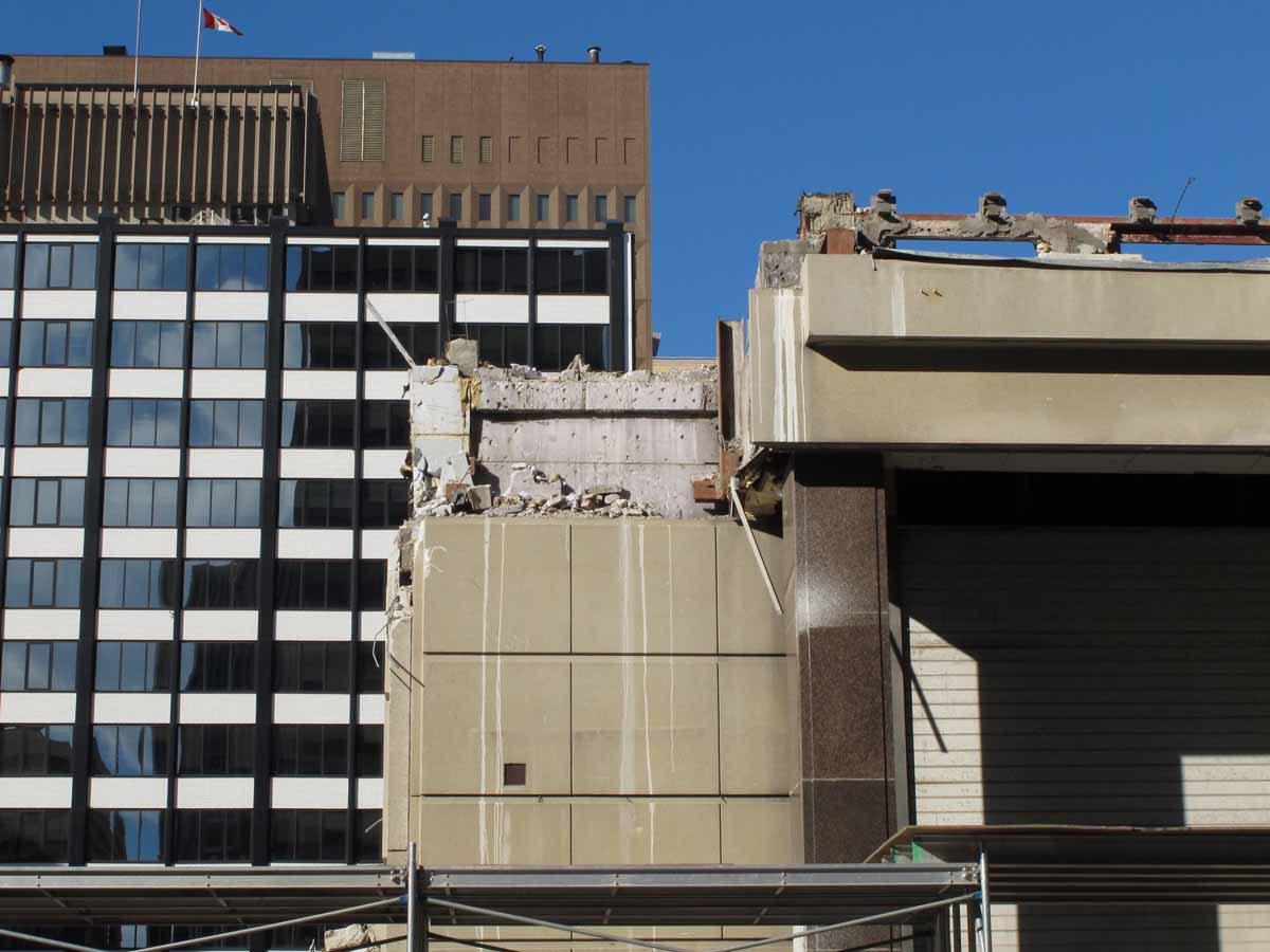 Detail of western extent of south elevation along Slater with concrete visible behind precast panel