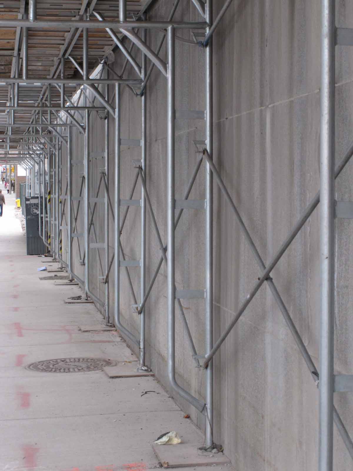 Scaffolding and granite panels of podium along Slater Street heading west