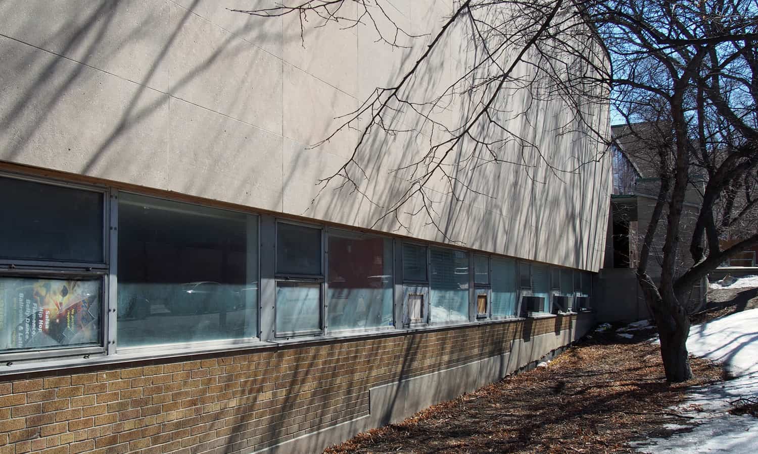 Ribbon window detail separating the brick base from the upper limestone cladding