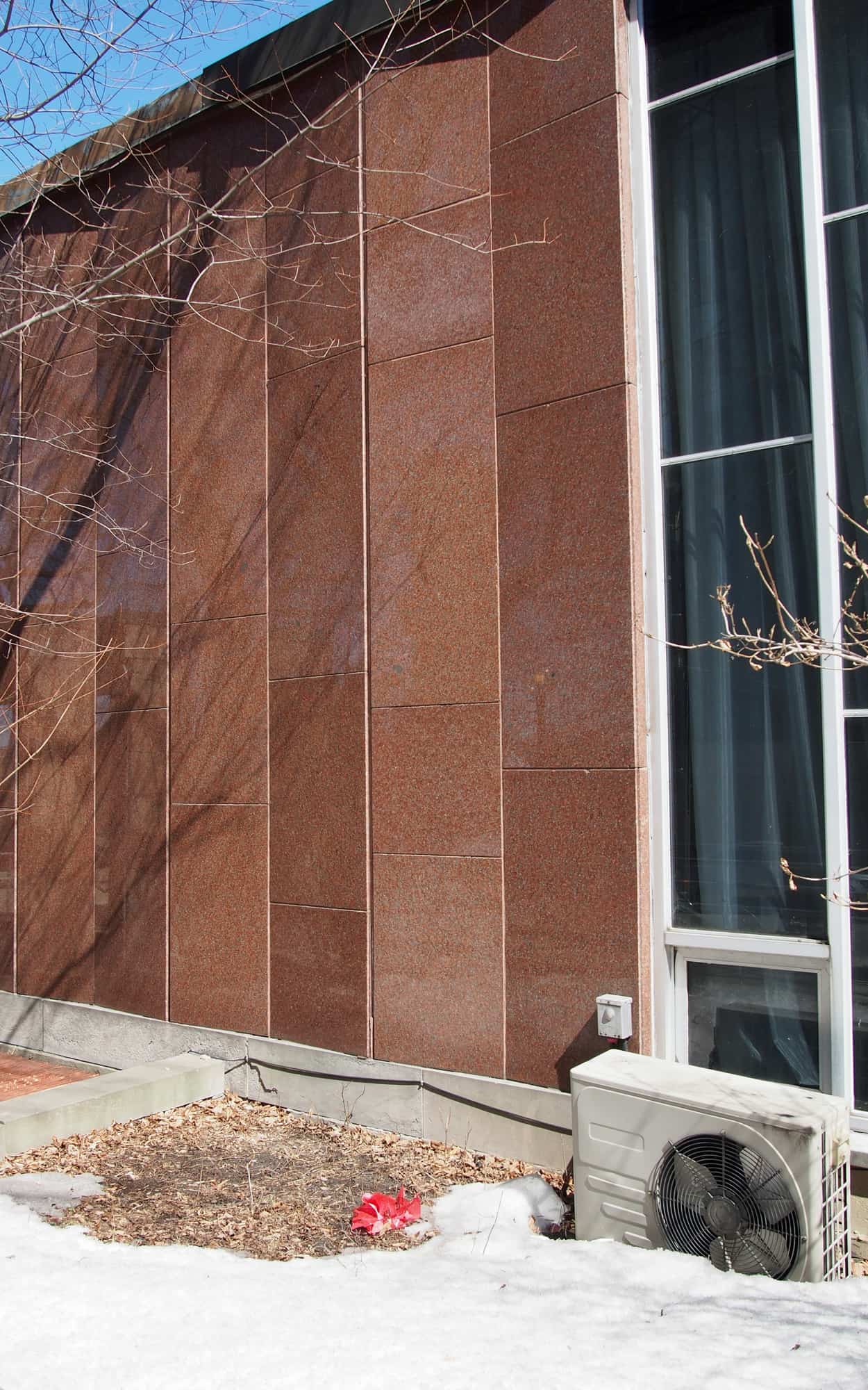 Chapel Street facade detail with vertically-orientated articulated red granite panels