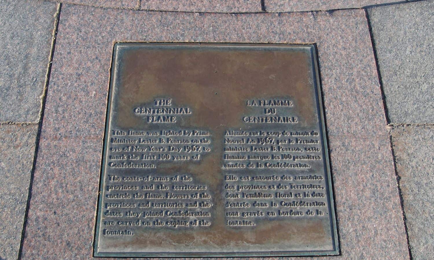 Plaque identifying the monument embedded in the pavers