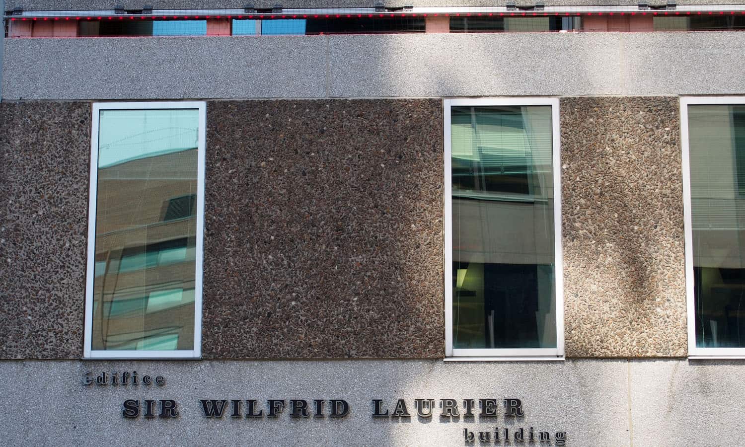 Detail of the precast cladding with its visible aggregate and vintage signage