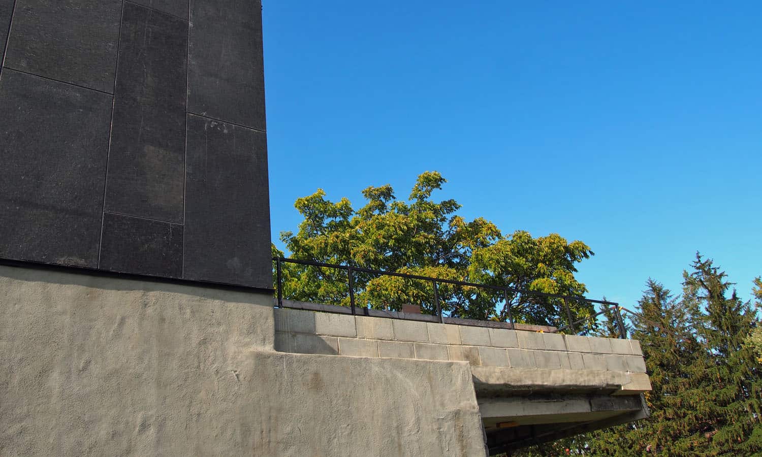 Capped end of the outdoor terrace that extend around the perimeter of the cafeteria wing