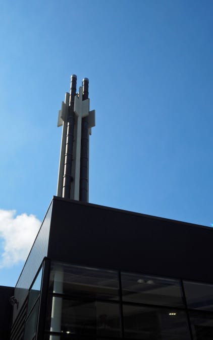 Exhaust stack rising above the rest of the generally low building